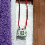 Set of 5 handcrafted silver square taweez with intricate Islamic design and free Bhojpatra sheet placed beside them