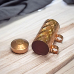 Set of 5 pure copper cylindrical taweez with Bhojpatra prayer sheets arranged on a neutral background