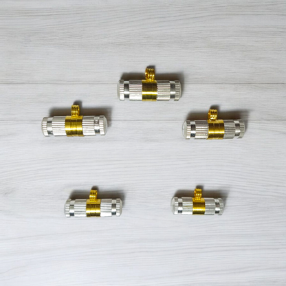 Set of 5 silver and golden Taweez amulets with detailed craftsmanship and a rolled Bhojpatra sheet beside them