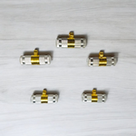 Set of 5 silver and golden Taweez amulets with detailed craftsmanship and a rolled Bhojpatra sheet beside them
