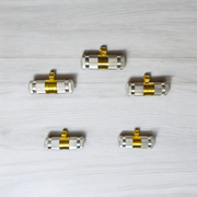 Set of 5 silver and golden Taweez amulets with detailed craftsmanship and a rolled Bhojpatra sheet beside them