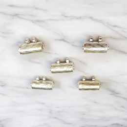 Set of five silver metal taweez amulets with Bhojpatra sheets, displayed against a white background