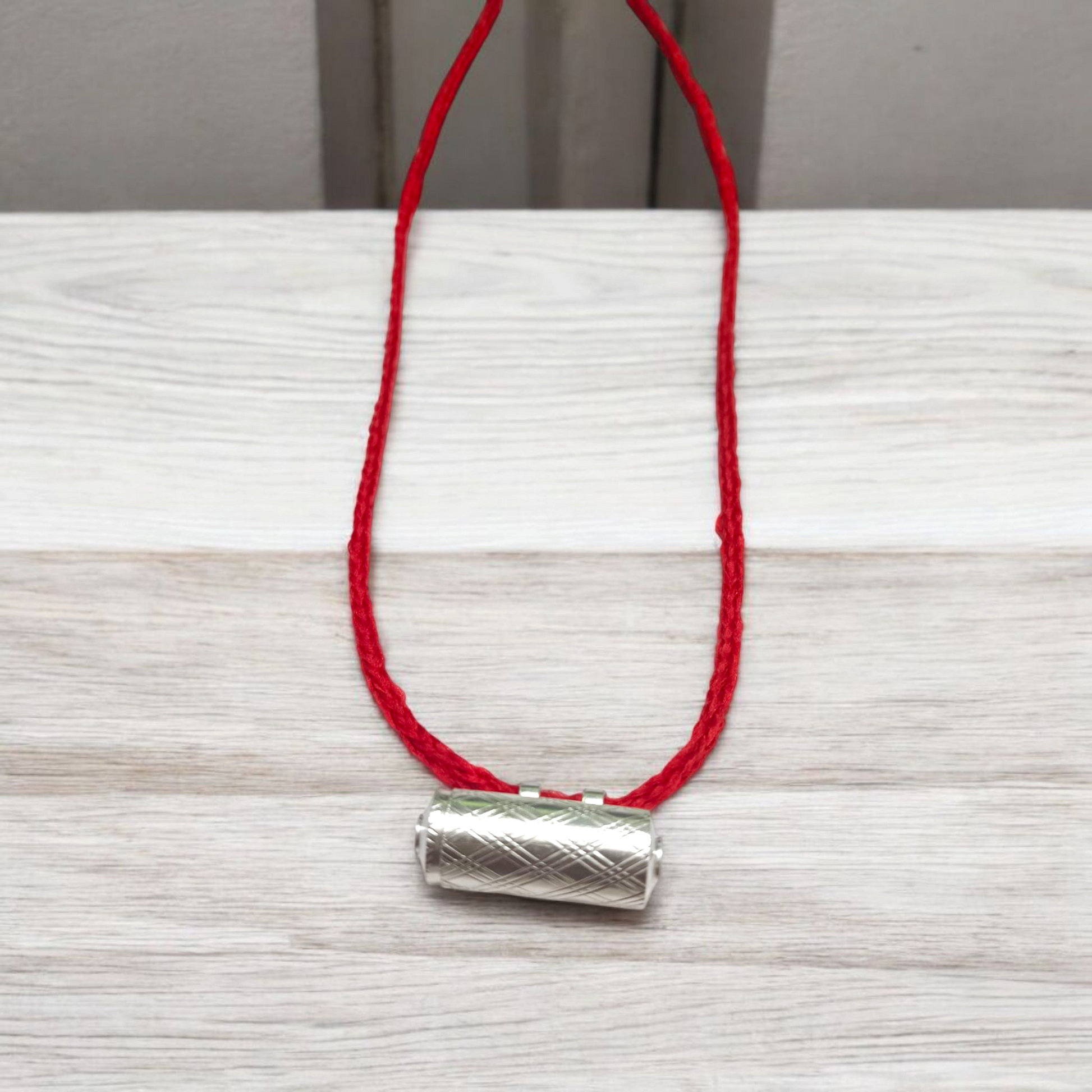 Set of five silver metal taweez amulets with Bhojpatra sheets, displayed against a white background