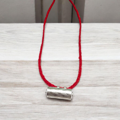 Set of five silver metal taweez amulets with Bhojpatra sheets, displayed against a white background
