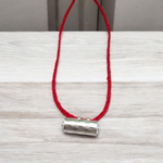 Set of five silver metal taweez amulets with Bhojpatra sheets, displayed against a white background