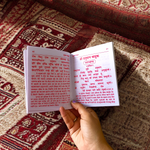 Shri Hanuman Bahuk Hindi Book with vibrant devotional artwork cover placed near Hanuman idol and diya