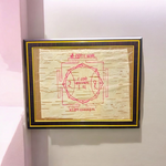 Shri Hanuman Yantra inscribed on Bhojpatra, framed in an antique wooden frame with glass cover, placed on a wooden altar.