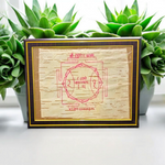 Shri Hanuman Yantra inscribed on Bhojpatra, framed in an antique wooden frame with glass cover, placed on a wooden altar.