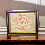 Shri Hanuman Yantra inscribed on Bhojpatra, framed in an antique wooden frame with glass cover, placed on a wooden altar.