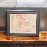 Shri Vastu Dosh Nivaran Yantra inscribed on Bhojpatra and framed in a premium wooden frame with a golden finish, placed on a decorative background