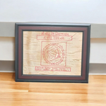 Shri Vastu Dosh Nivaran Yantra inscribed on Bhojpatra and framed in a premium wooden frame with a golden finish, placed on a decorative background