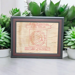 Shri Vastu Dosh Nivaran Yantra inscribed on Bhojpatra and framed in a premium wooden frame with a golden finish, placed on a decorative background