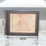 Shri Vastu Dosh Nivaran Yantra inscribed on Bhojpatra and framed in a premium wooden frame with a golden finish, placed on a decorative background