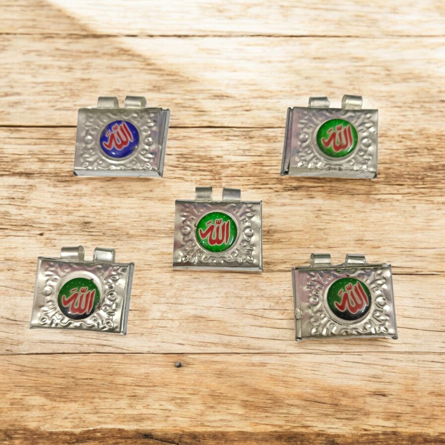 Silver square taweez set with Bhojpatra sheets arranged neatly on a decorative cloth background