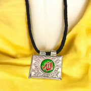 Silver square taweez set with Bhojpatra sheets arranged neatly on a decorative cloth background