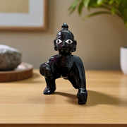 Small Black Laddu Gopal idol in sitting posture with intricate detailing, ideal for home temple and pooja
