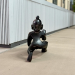 Small Black Laddu Gopal idol in sitting posture with intricate detailing, ideal for home temple and pooja