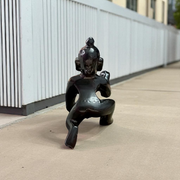 Small Black Laddu Gopal idol in sitting posture with intricate detailing, ideal for home temple and pooja