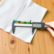 Stretchable 8mm bead Money Magnet Bracelet made of Green Aventurine, Citrine, and Pyrite crystals, lab certified, placed on a neutral background