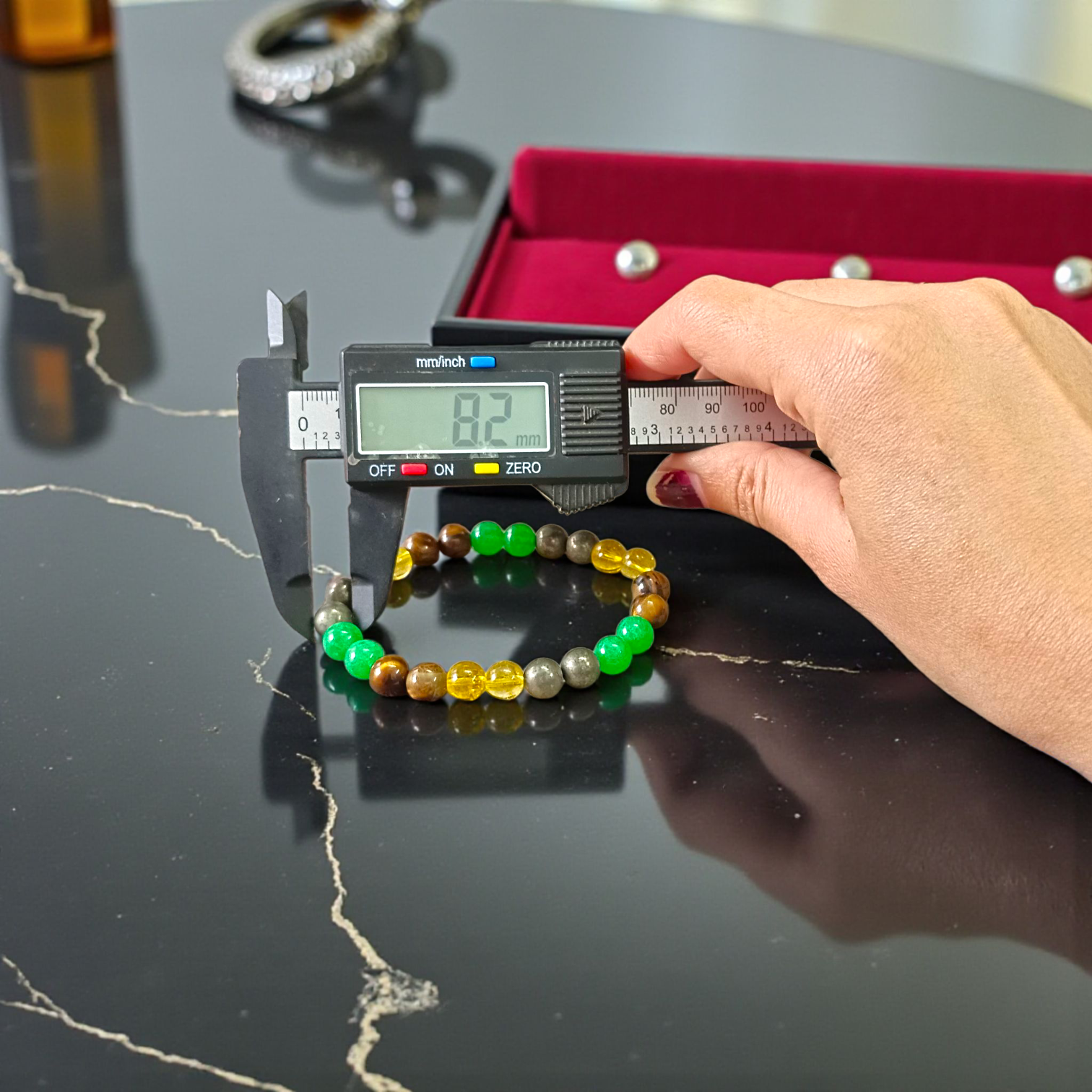 Stretchable 8mm bead Money Magnet Bracelet made of Green Aventurine, Citrine, and Pyrite crystals, lab certified, placed on a neutral background