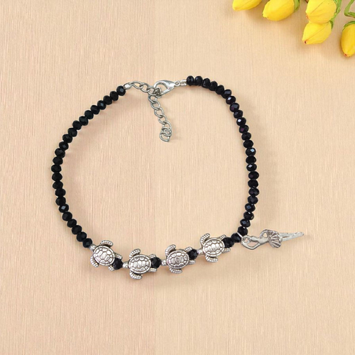 Stylish black crystal beads anklet featuring both Evil Eye and Tortoise charms, designed for unisex wear and spiritual protection