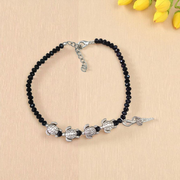 Stylish black crystal beads anklet featuring both Evil Eye and Tortoise charms, designed for unisex wear and spiritual protection