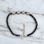 Stylish black crystal beads anklet featuring both Evil Eye and Tortoise charms, designed for unisex wear and spiritual protection