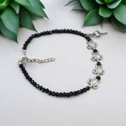 Stylish black crystal beads anklet featuring both Evil Eye and Tortoise charms, designed for unisex wear and spiritual protection