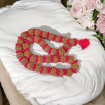 Traditional 5 Mukhi Rudraksha Kantha Mala with 108 beads, laid in a spiral on a wooden surface