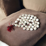 Traditional Nar Mund Mala with skull-shaped beads tied in red thread, arranged on a dark spiritual altar cloth