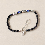 Unisex black crystal beads anklet featuring protective Evil Eye and lucky Fish charms, handcrafted for spiritual style and daily wear