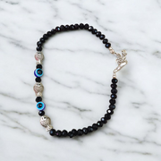 Unisex black crystal beads anklet featuring protective Evil Eye and lucky Fish charms, handcrafted for spiritual style and daily wear