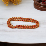 Wired Rudraksha Mala featuring 5mm Rudraksha beads wrapped in golden wire, neatly handcrafted and ideal for meditation or daily wear