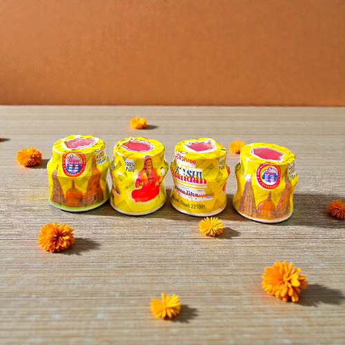 Yellow chandan paste container used for tilak, puja, and religious rituals