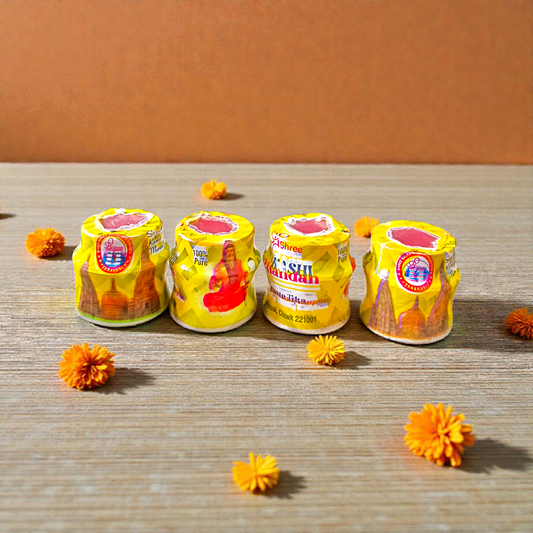 Yellow chandan paste container used for tilak, puja, and religious rituals