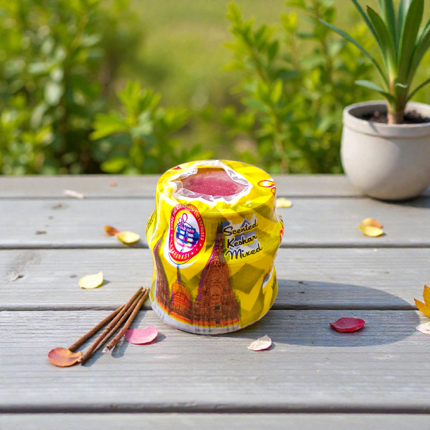 Yellow chandan paste container used for tilak, puja, and religious rituals