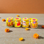 Yellow chandan paste container used for tilak, puja, and religious rituals