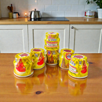 Yellow chandan paste container used for tilak, puja, and religious rituals