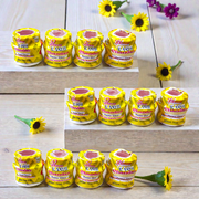 Yellow chandan paste container used for tilak, puja, and religious rituals