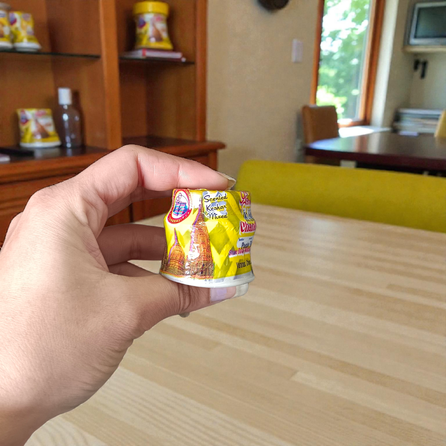 Yellow, red, and white chandan paste containers used for tilak, puja, and religious rituals