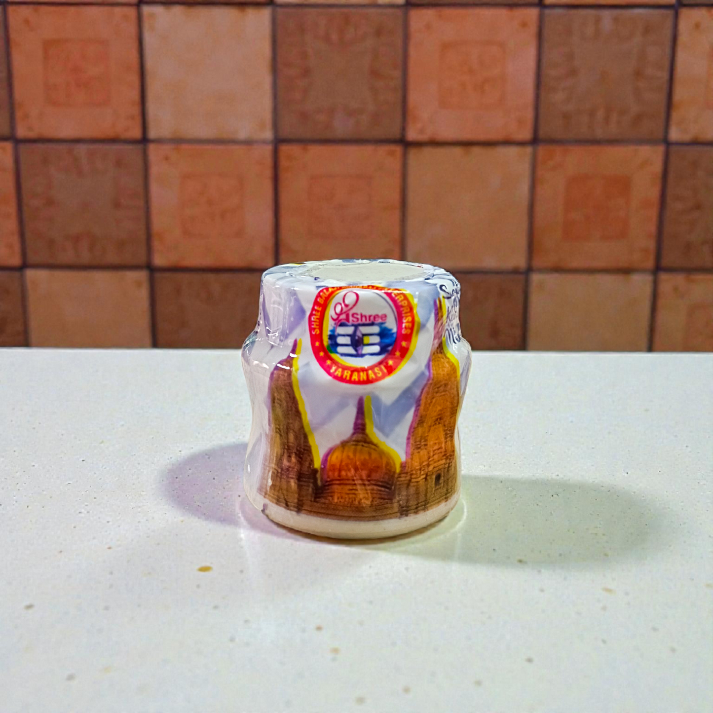 Yellow, red, and white chandan paste containers used for tilak, puja, and religious rituals